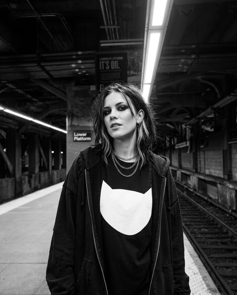 Subway platform, black & white Editorial portrait on a subway platform, black and white, industrial station lighting and tracks